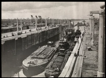 View of dredges and boats at a lock in the Panama Canal during construction